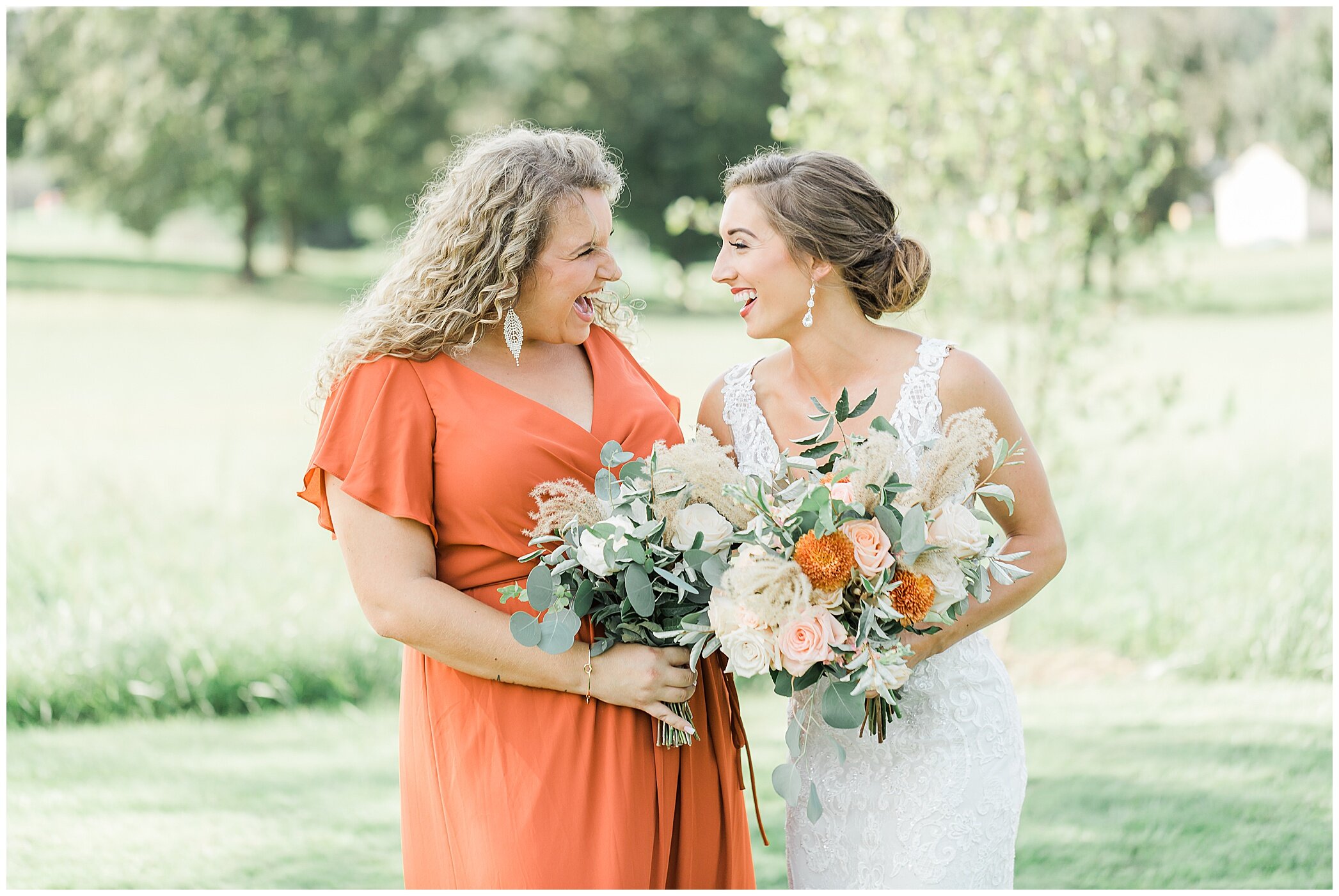 bride laughs with bridesmaid in burnt orange bridesmaid dress