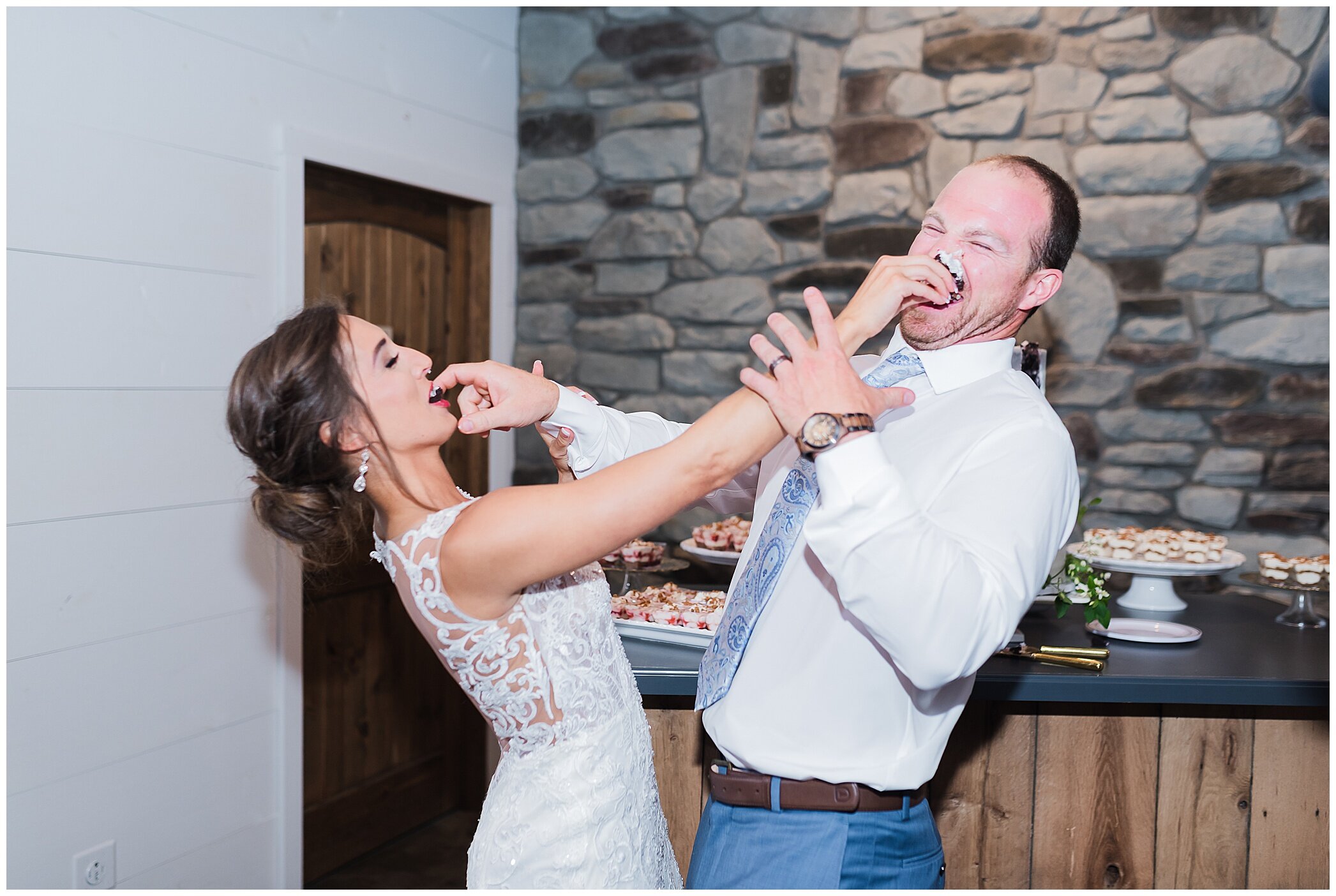 bride and groom smash cake during wedding reception