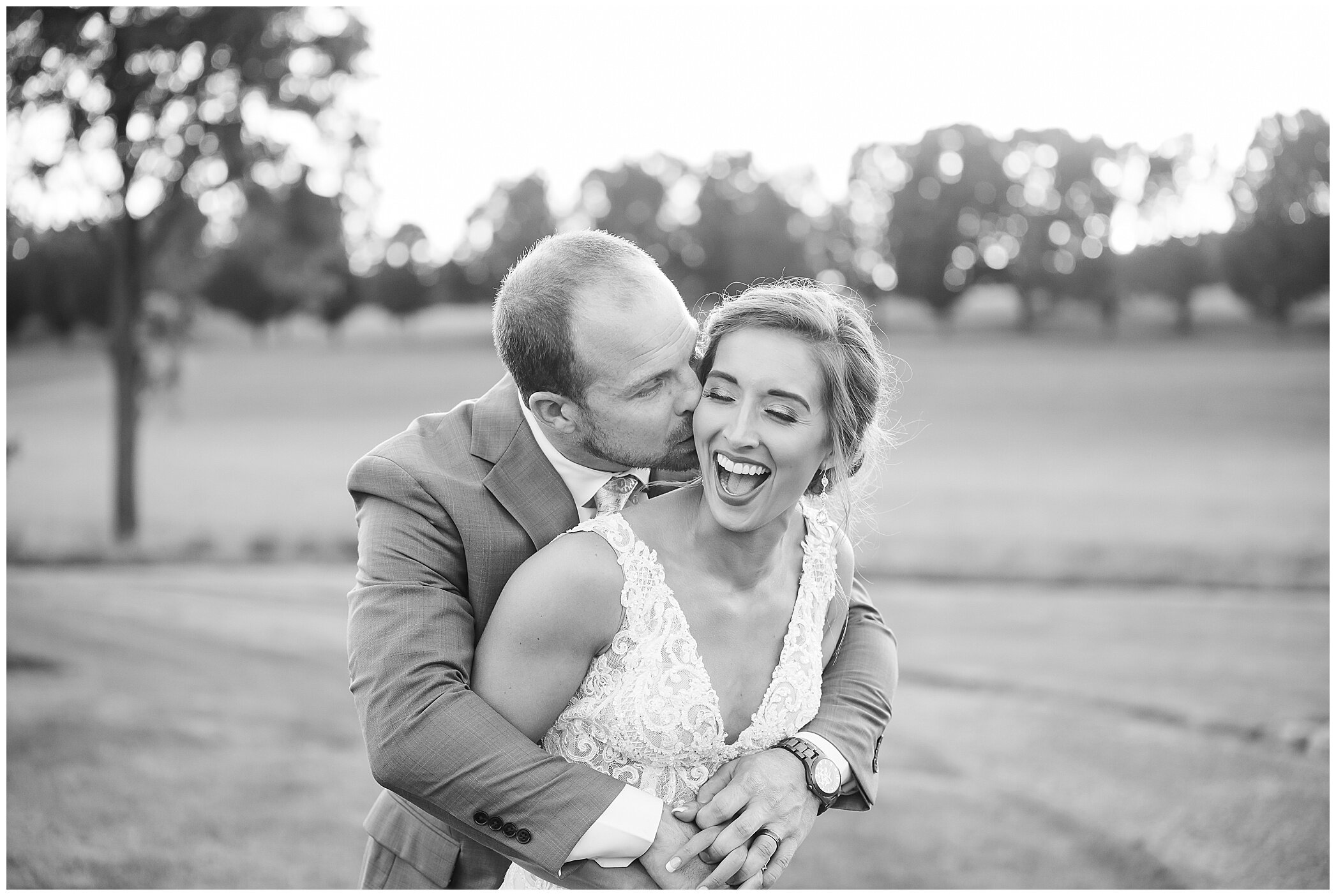 bride and groom laugh during fall wedding day