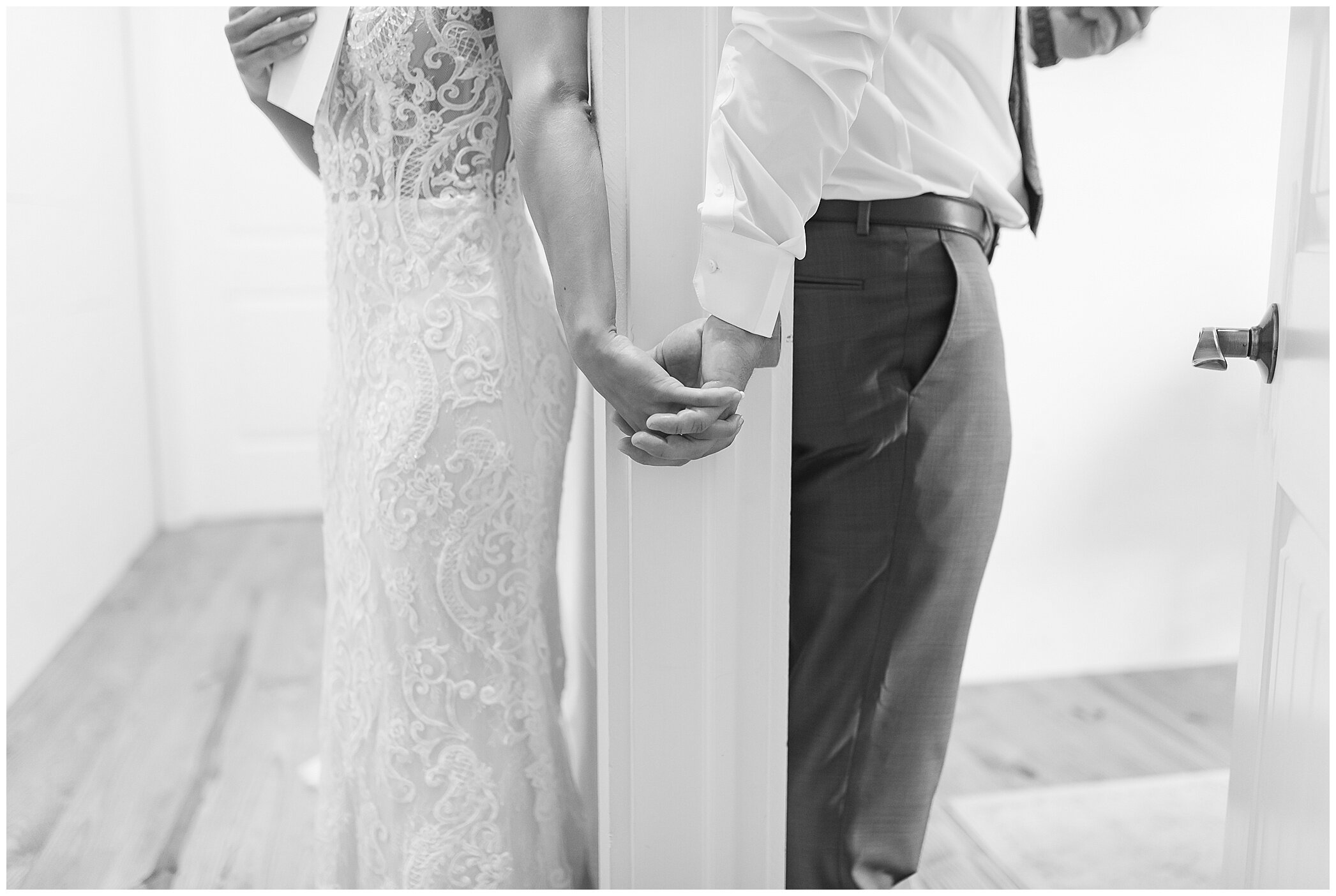 bride and groom hold hands around door and read letters