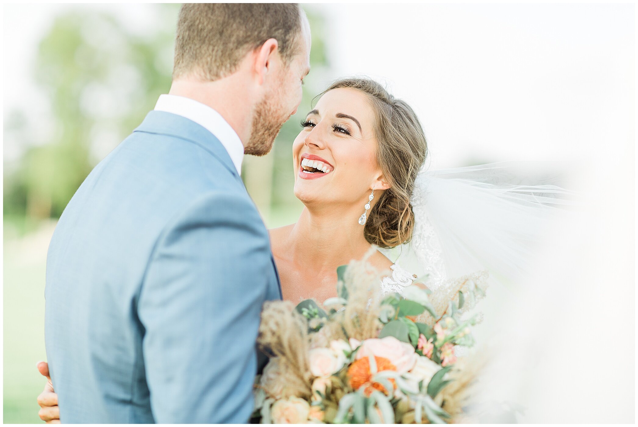 bride laughs while talking to groom on wedding day