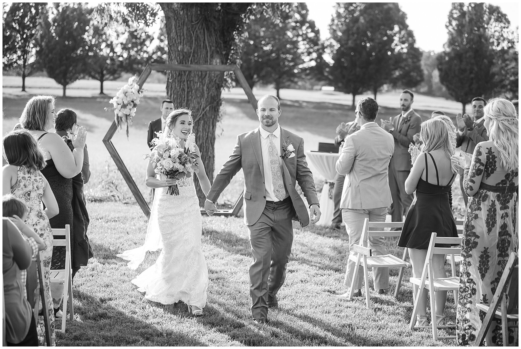 bride and groom walk up aisle after wedding ceremony 