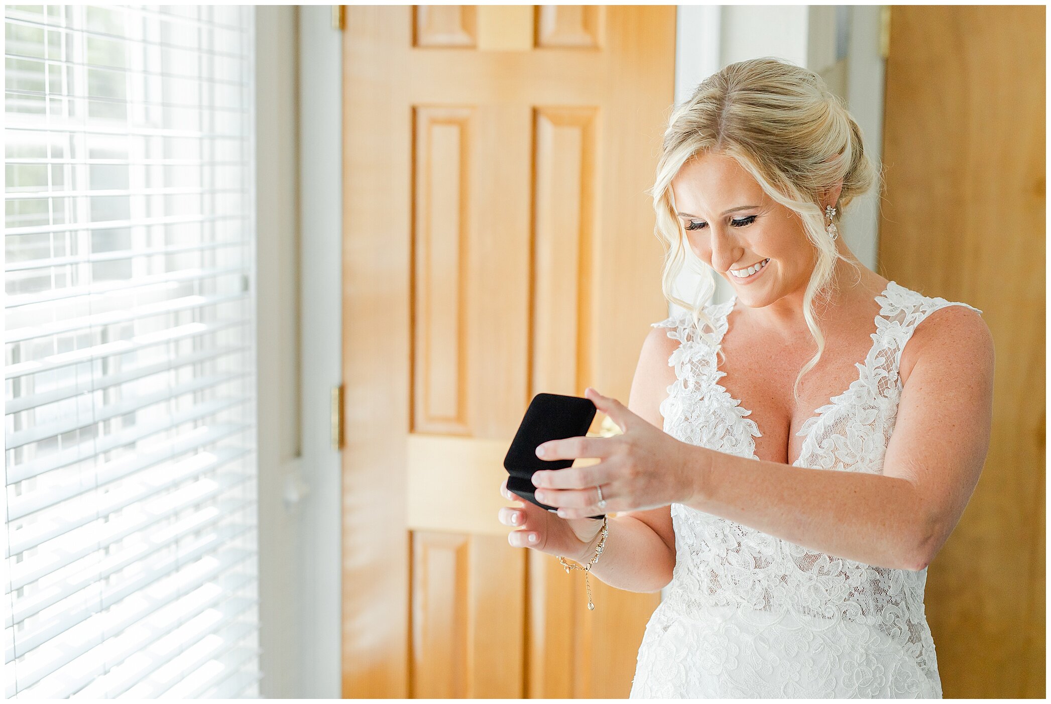 bride opens gift from groom on wedding day