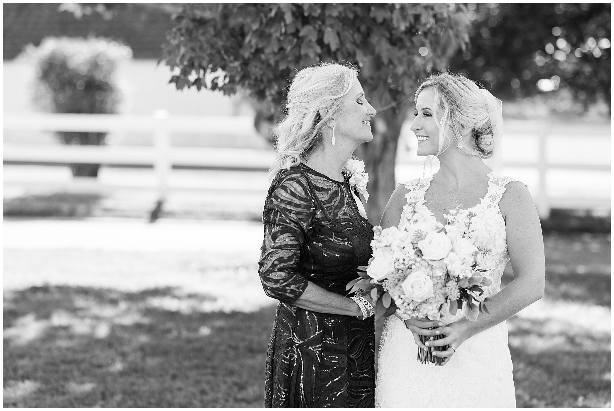 mom and bride look at each other during family portraits after Suffolk VA wedding