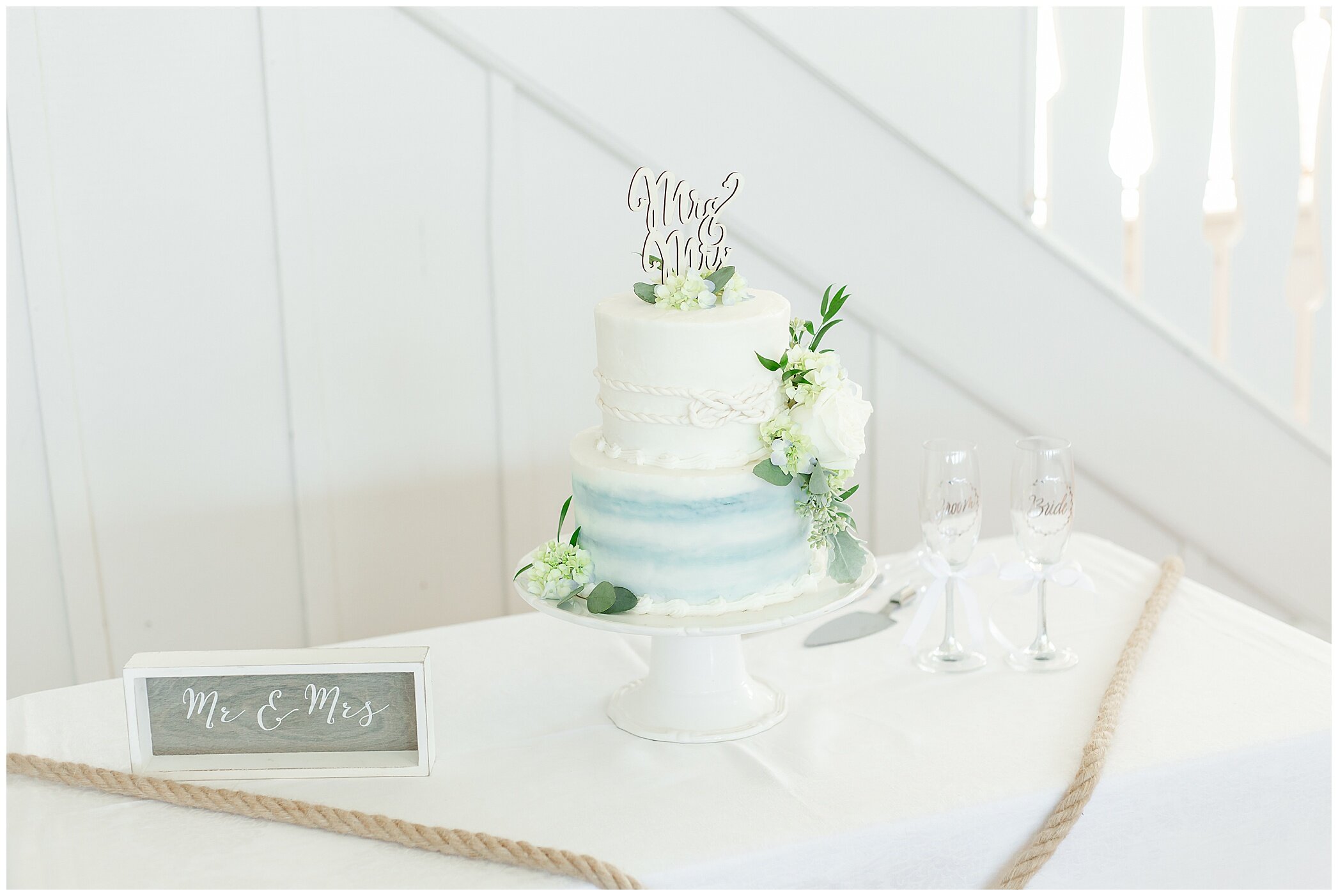 tiered wedding cake with blue and white details