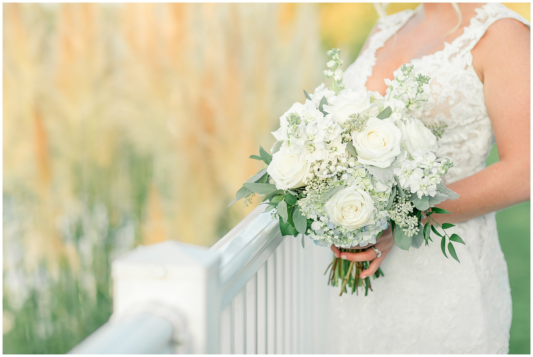 bride holds bouquet of white flowers In Suffolk VA