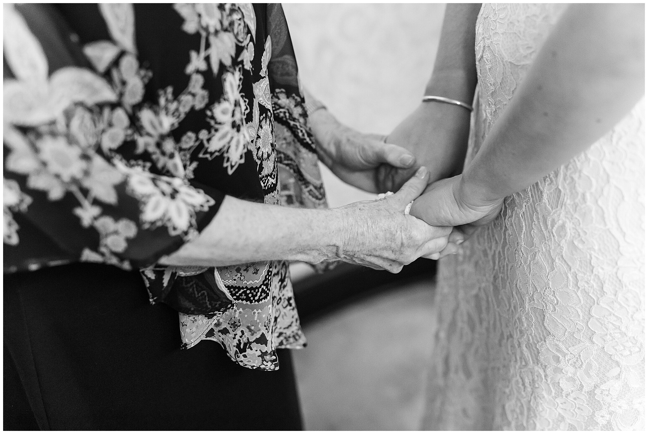 grandmother and bride hold hands before VA wedding