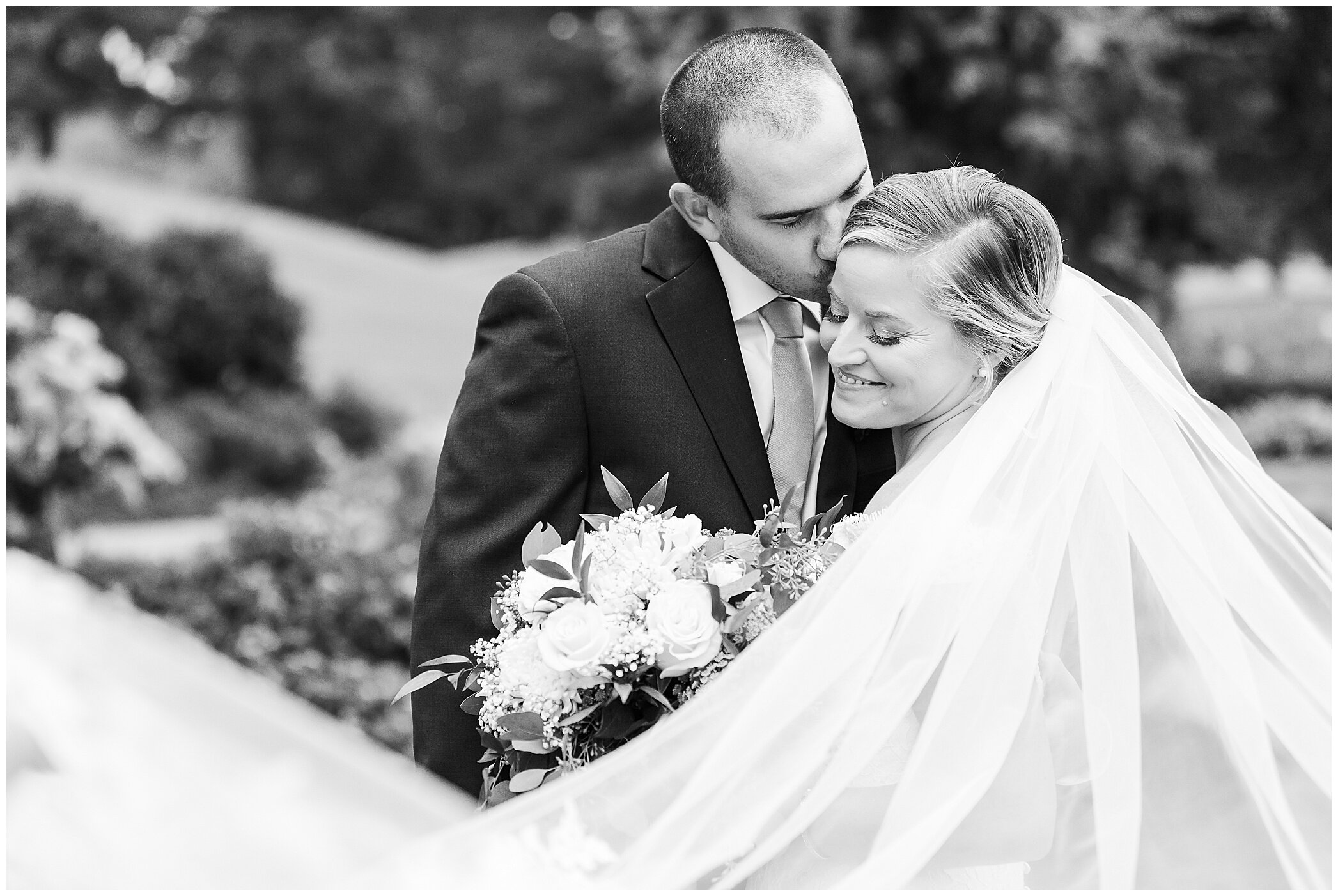 groom kisses bride's forehead during VA wedding photos