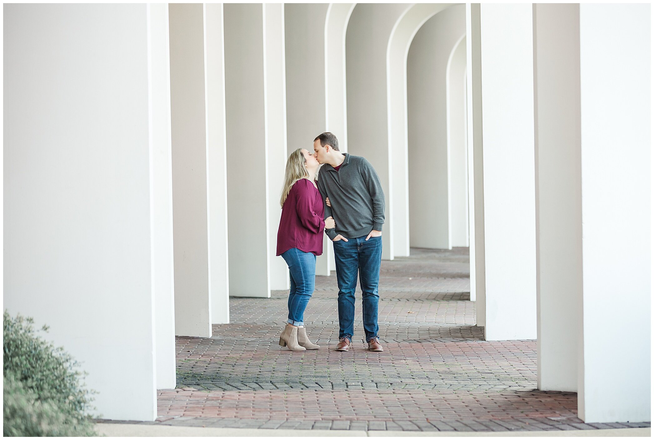 bride and groom pose by theater at Christopher Newport University