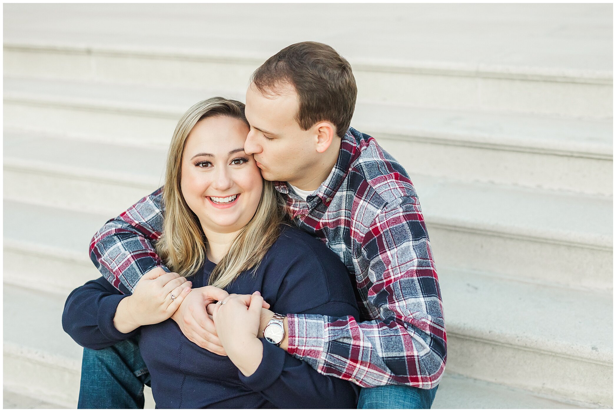 engaged couple poses on steps at Christopher Newport University