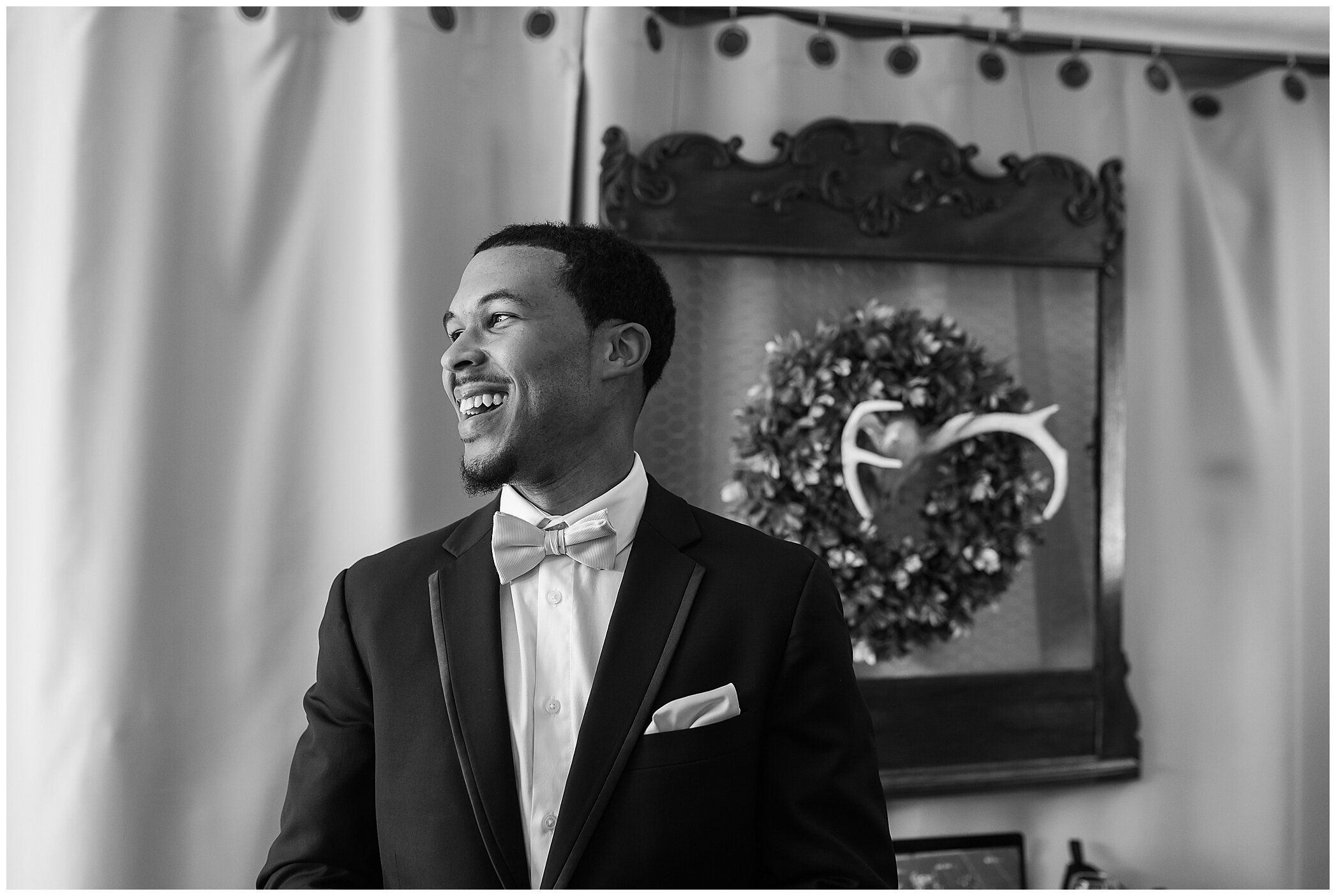 groom laughs while preparing for VA wedding day