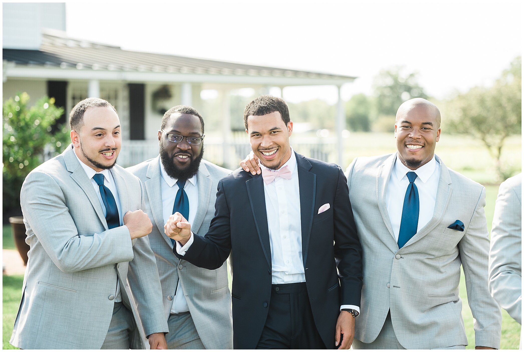 groom fist bumps groomsmen during VA wedding day