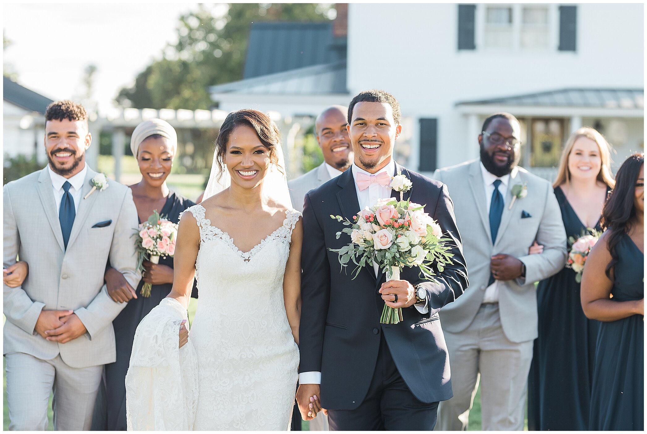 bride and groom walk with bridesmaids in teal gowns and groomsmen in grey suits at The Barns at Timberneck