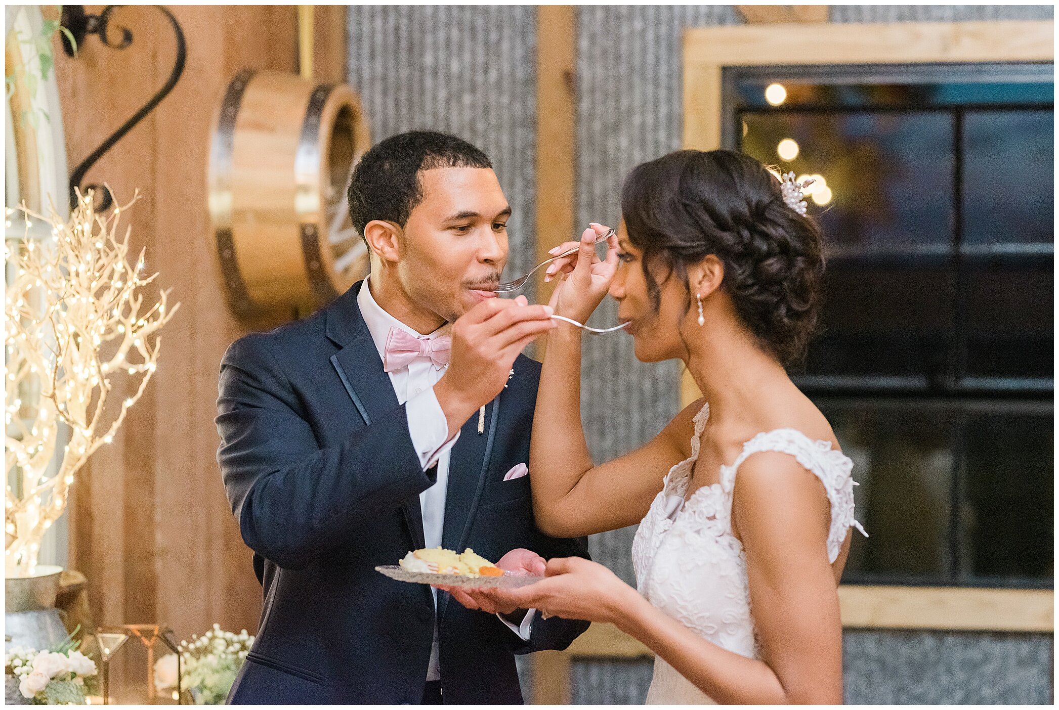 bride and groom eat cake during The Barns at Timberneck reception 